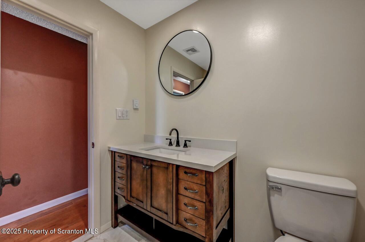 219 Noble Road Clarks Summit, PA 18411 - Photo 24 of 47 a bathroom with a toilet a sink and a mirror