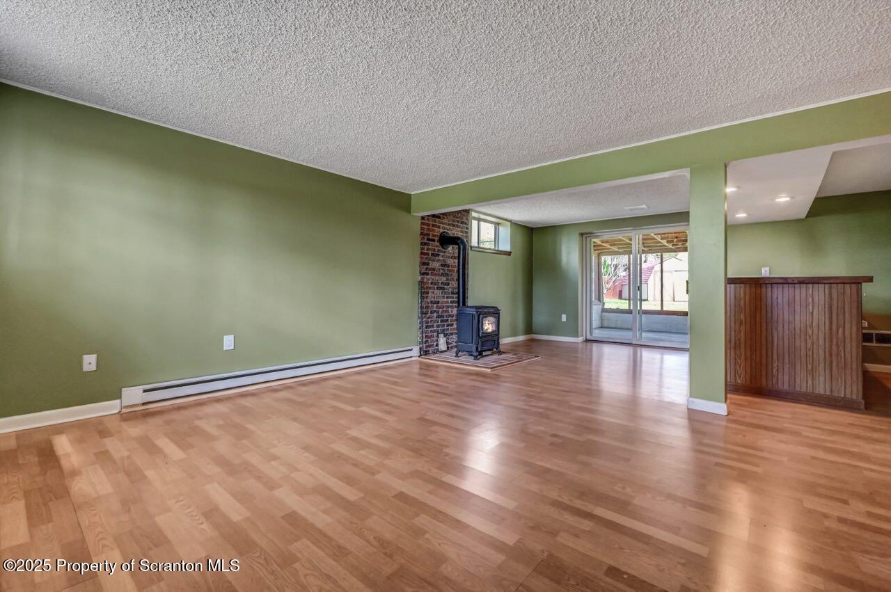 219 Noble Road Clarks Summit, PA 18411 - Photo 31 of 47 an empty room with wooden floor and windows