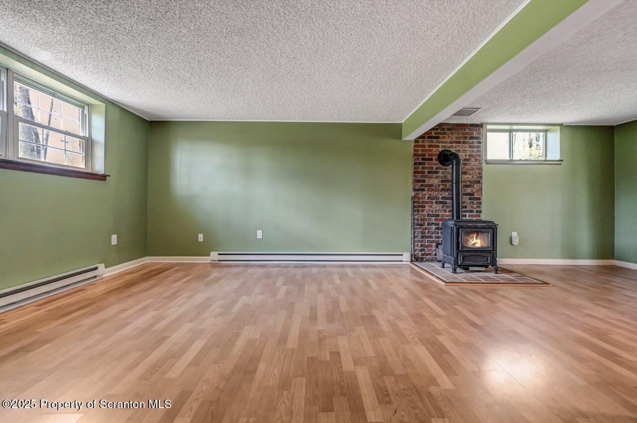 219 Noble Road Clarks Summit, PA 18411 - Photo 32 of 47 an empty room with wooden floor and windows