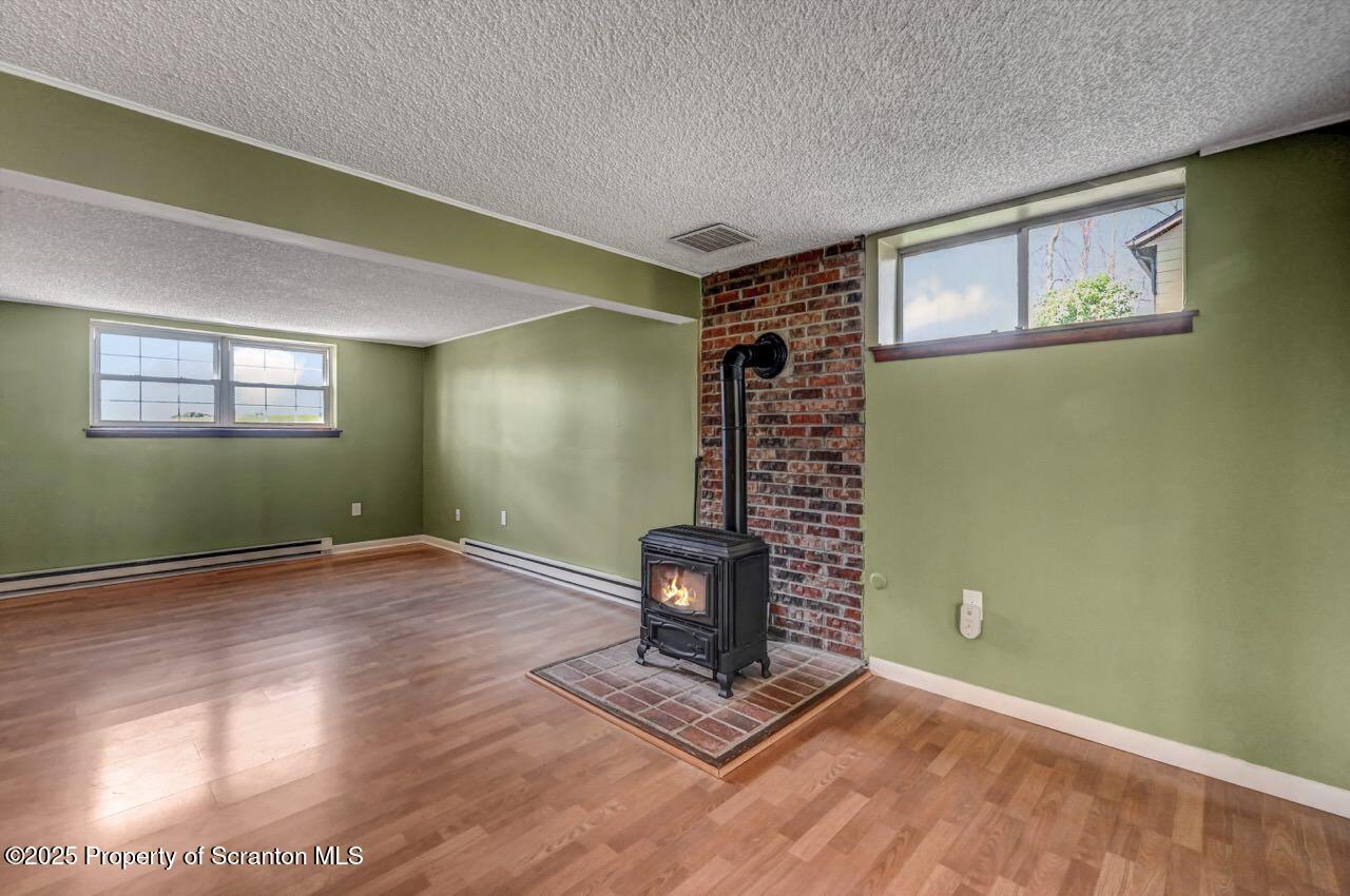 219 Noble Road Clarks Summit, PA 18411 - Photo 35 of 47 a view of an empty room with window and wooden floor