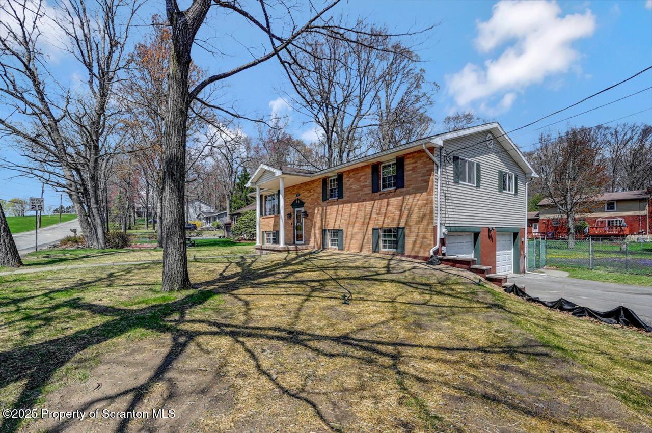 219 Noble Road Clarks Summit, PA 18411 - Photo 45 of 47 a front view of a house with a yard