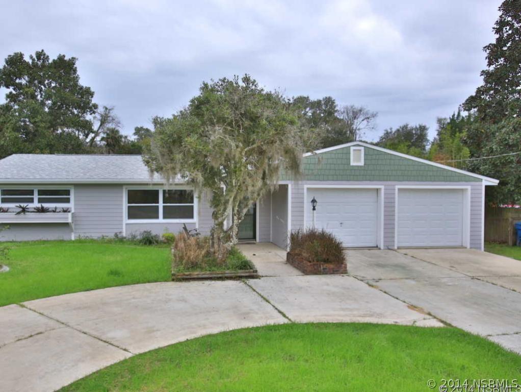 2738 Letha Road New Smyrna Beach, FL 32168 - Photo 1 of 21 a front view of a house with a yard and garage