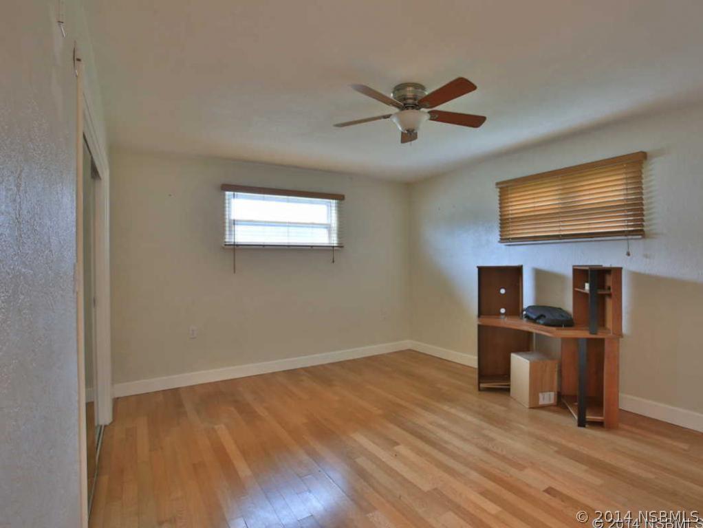 2738 Letha Road New Smyrna Beach, FL 32168 - Photo 11 of 21 a view of empty room with wooden floor and fan