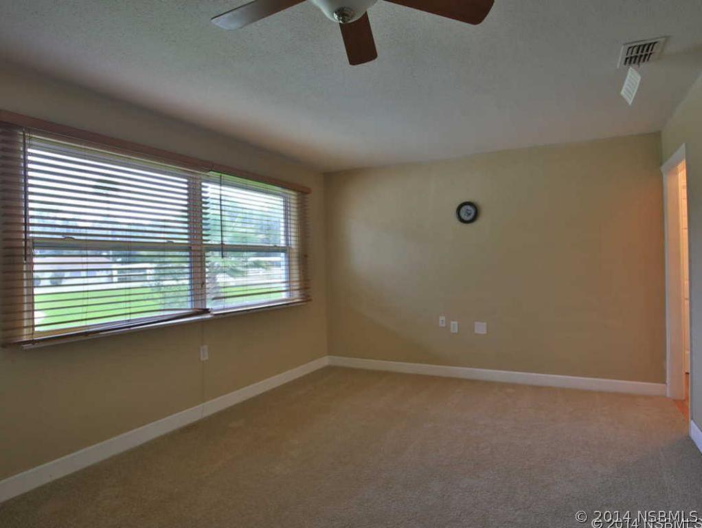 2738 Letha Road New Smyrna Beach, FL 32168 - Photo 12 of 21 an empty room with windows