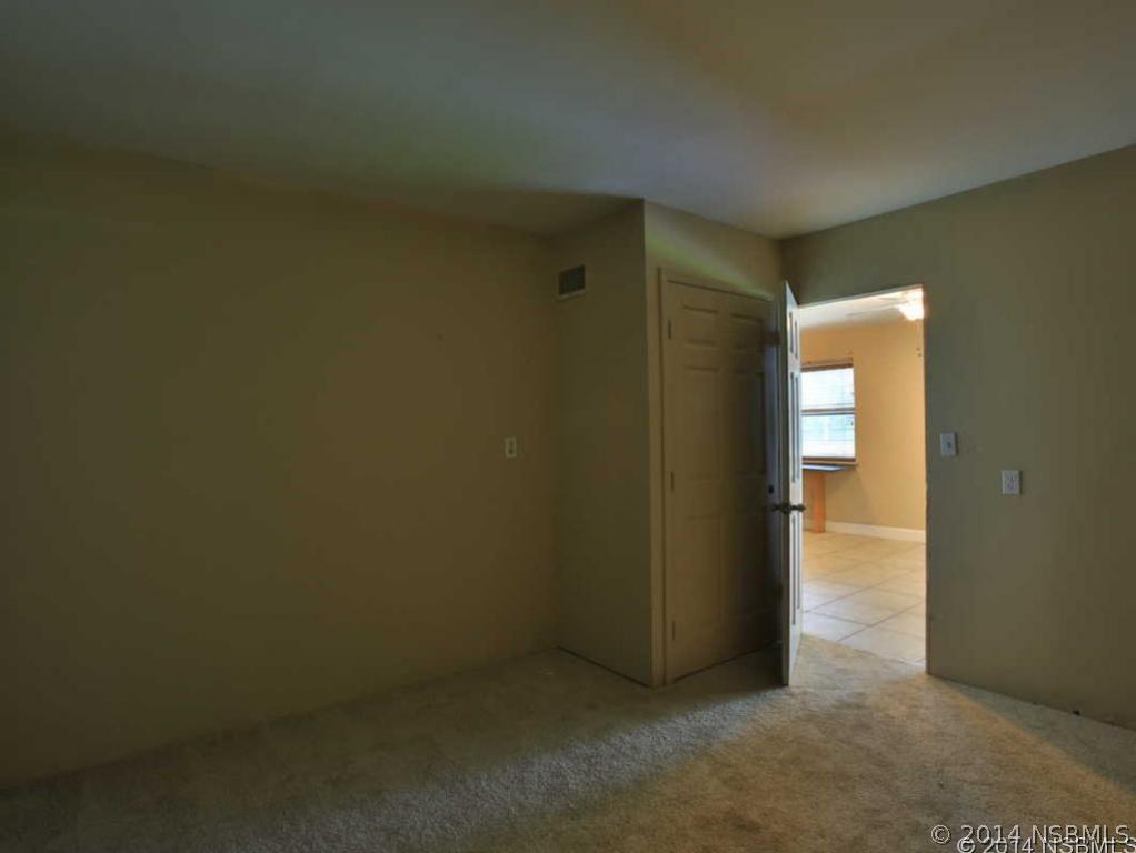 2738 Letha Road New Smyrna Beach, FL 32168 - Photo 15 of 21 an empty room with wooden floor and a window