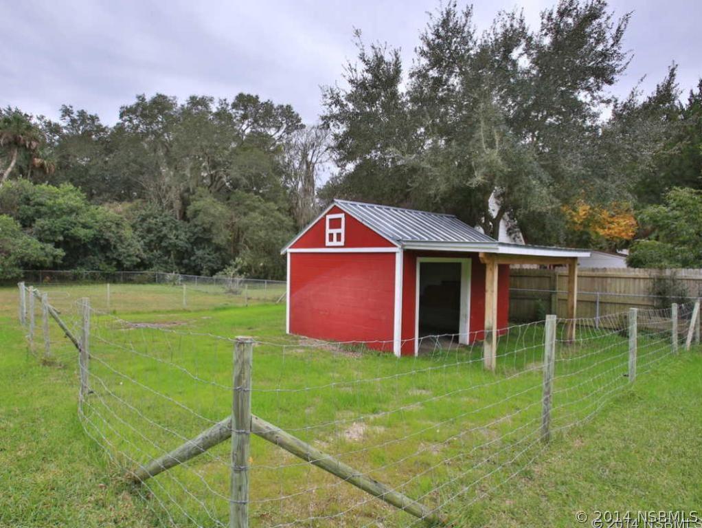 2738 Letha Road New Smyrna Beach, FL 32168 - Photo 17 of 21 a view of an house with backyard space and balcony