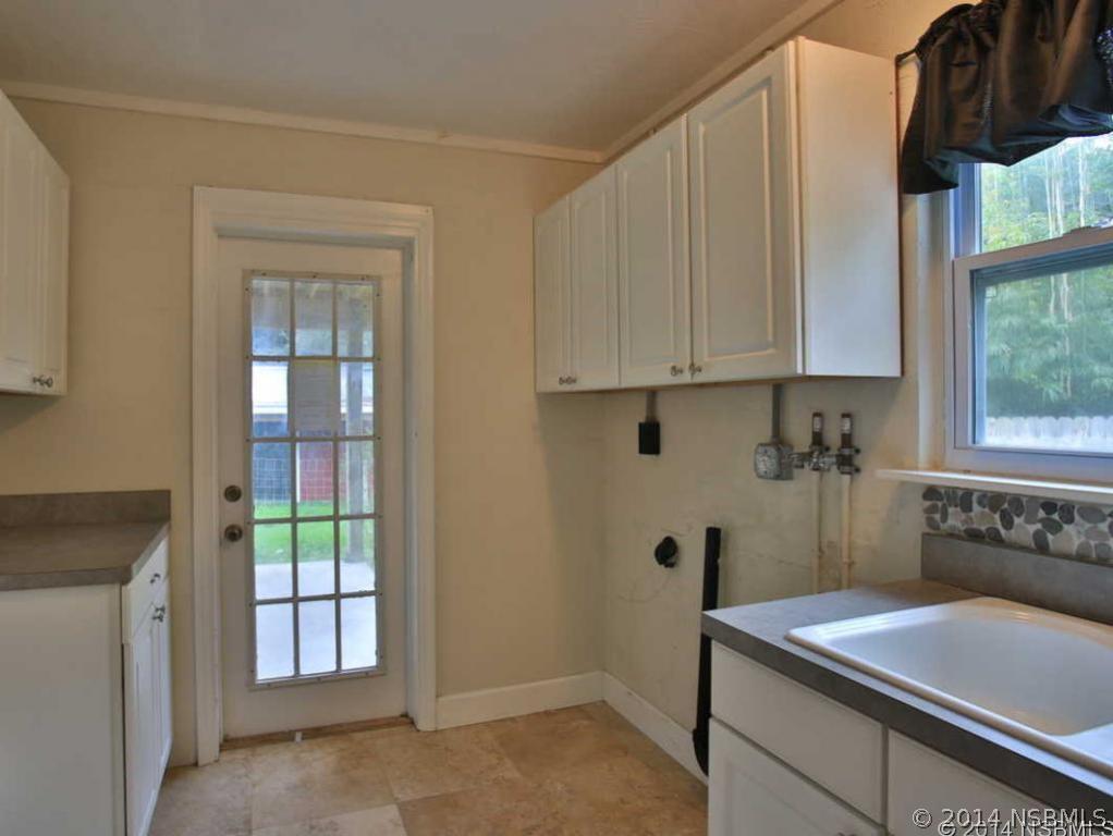 2738 Letha Road New Smyrna Beach, FL 32168 - Photo 18 of 21 a room with a sink and cabinets
