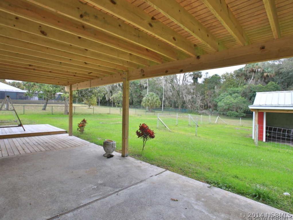 2738 Letha Road New Smyrna Beach, FL 32168 - Photo 20 of 21 a view of a house with backyard and a backyard