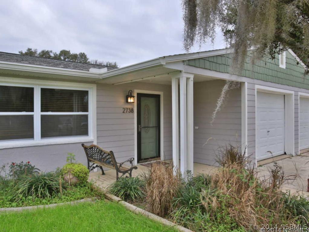 2738 Letha Road New Smyrna Beach, FL 32168 - Photo 2 of 21 front view of a house with a yard