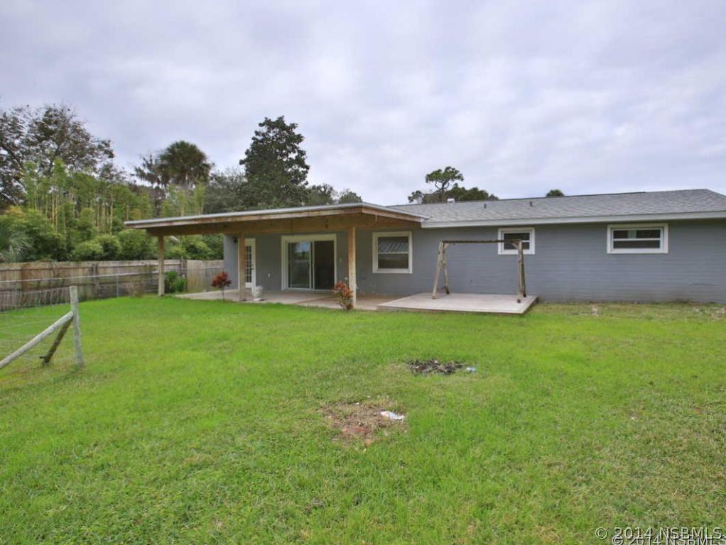 2738 Letha Road New Smyrna Beach, FL 32168 - Photo 21 of 21 a front view of house with yard and green space