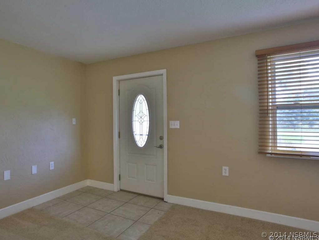 2738 Letha Road New Smyrna Beach, FL 32168 - Photo 3 of 21 an empty room with windows