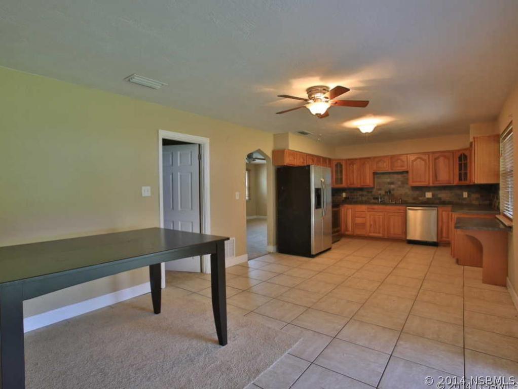 2738 Letha Road New Smyrna Beach, FL 32168 - Photo 5 of 21 a living room with stainless steel appliances kitchen island granite countertop furniture and a kitchen view