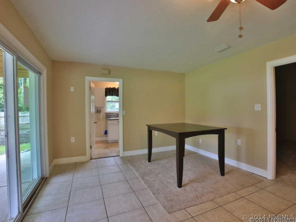2738 Letha Road New Smyrna Beach, FL 32168 - Photo 6 of 21 a view of an empty room with window and chandelier fan