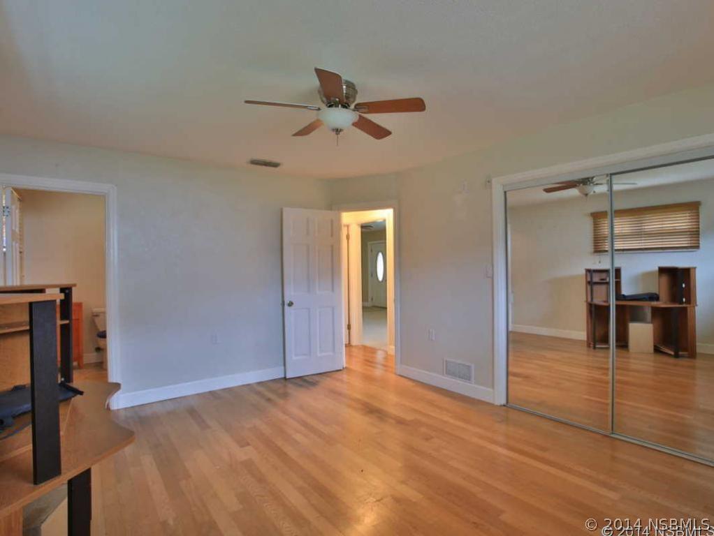 2738 Letha Road New Smyrna Beach, FL 32168 - Photo 8 of 21 a view of empty room with wooden floor