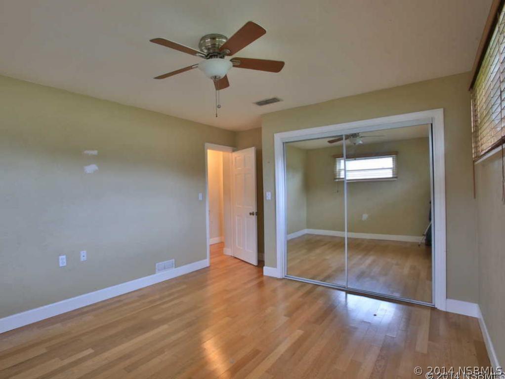 2738 Letha Road New Smyrna Beach, FL 32168 - Photo 9 of 21 wooden floor in an empty room with a window