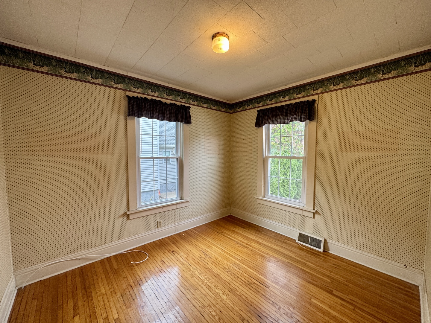 221 West Peru Street Princeton, IL 61356 - Photo 13 of 33 a view of an empty room with a window and wooden floor
