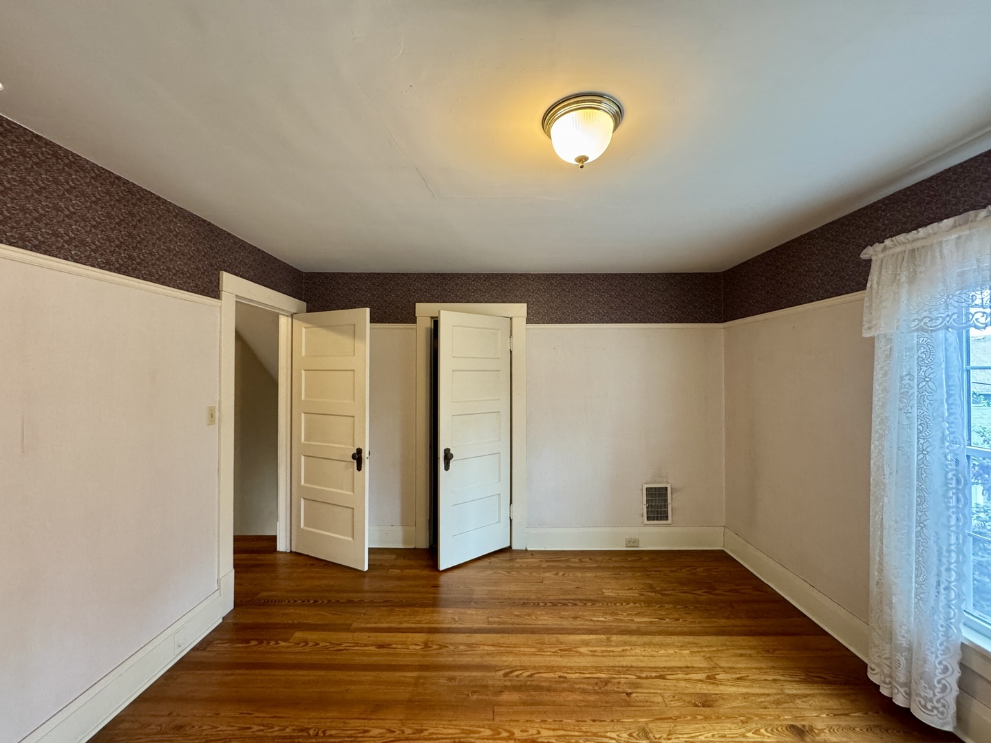 221 West Peru Street Princeton, IL 61356 - Photo 17 of 33 a view of an empty room with wooden floor and closet