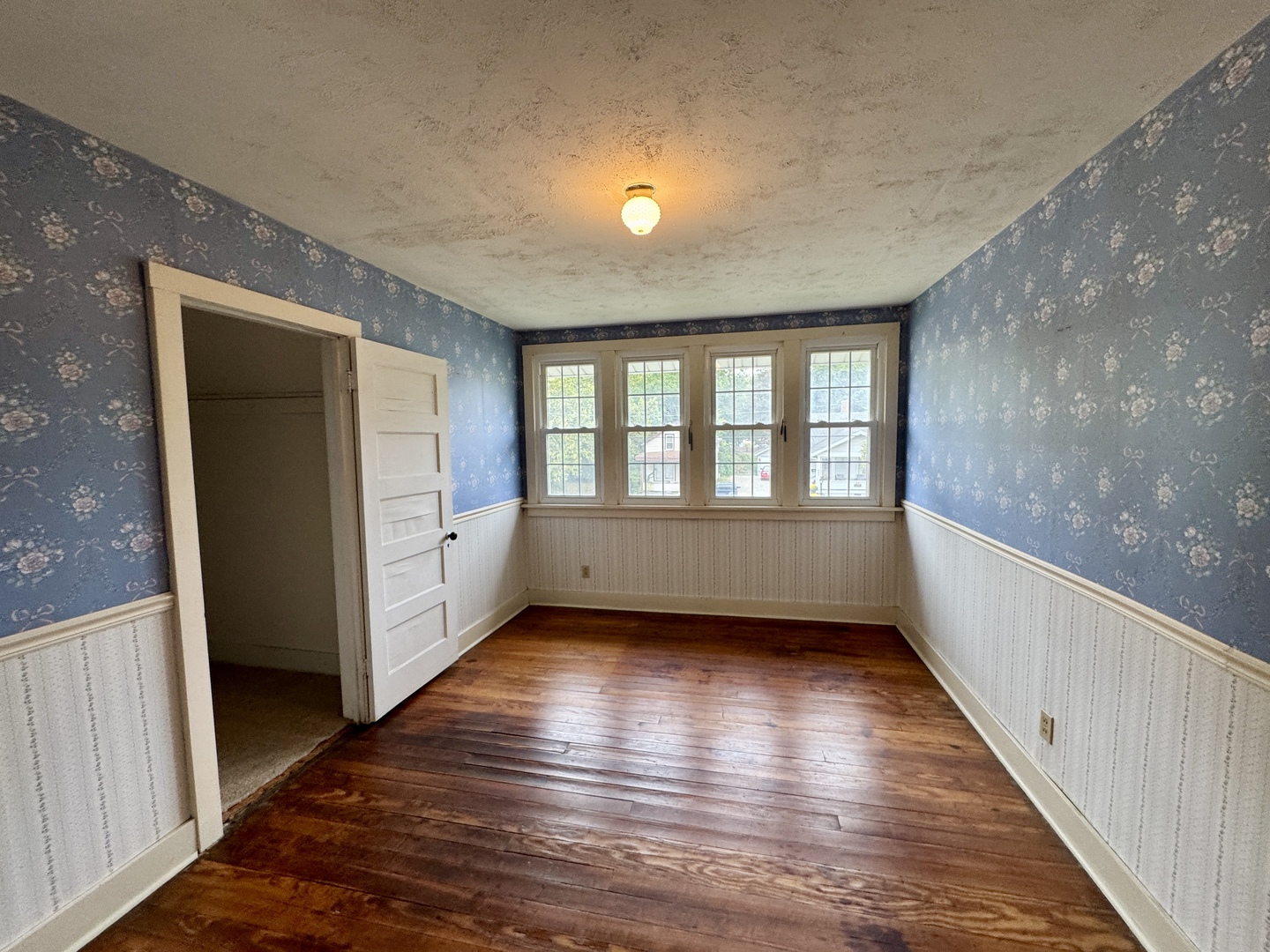221 West Peru Street Princeton, IL 61356 - Photo 19 of 33 a view of an empty room with wooden floor and a window