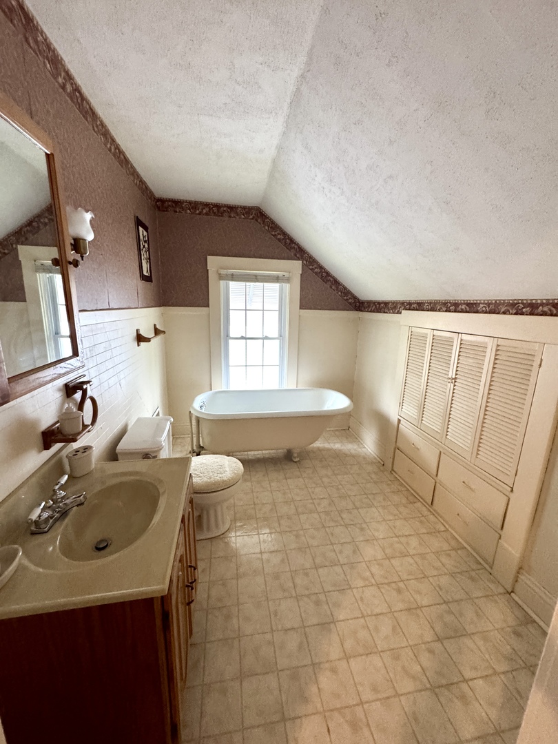 221 West Peru Street Princeton, IL 61356 - Photo 23 of 33 a bathroom with a sink toilet and tub