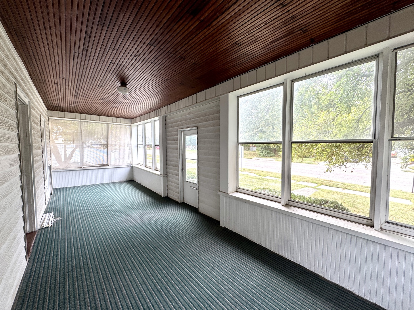221 West Peru Street Princeton, IL 61356 - Photo 4 of 33 a view of an empty room with a window and wooden floor