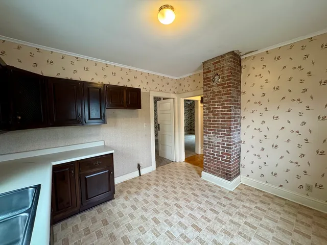 a view of a kitchen with wooden floor