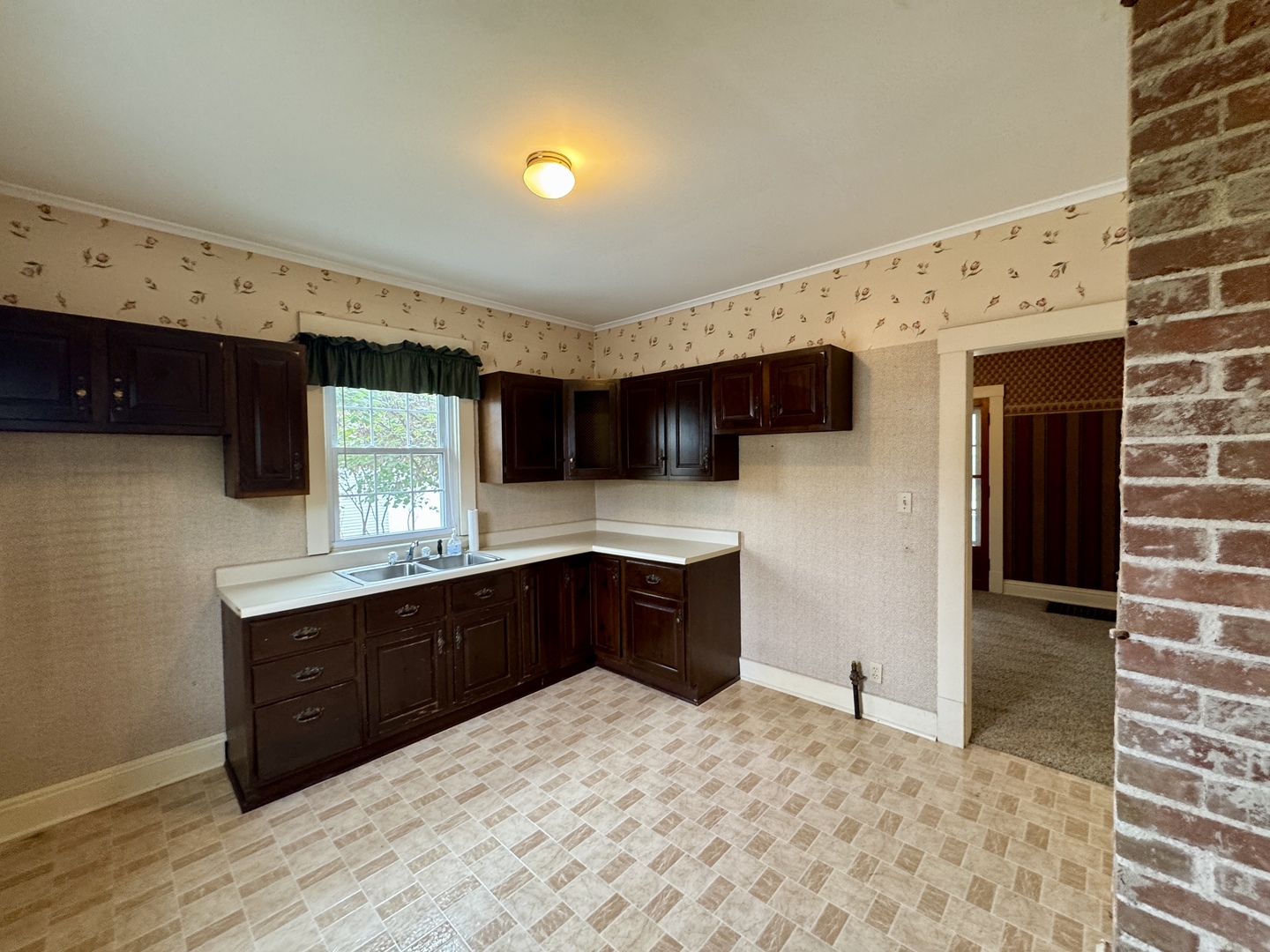 221 West Peru Street Princeton, IL 61356 - Photo 7 of 33 a large kitchen with stainless steel appliances a sink stove and cabinets