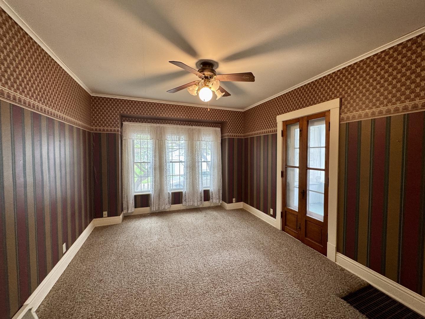 221 West Peru Street Princeton, IL 61356 - Photo 9 of 33 wooden floor and windows in an empty room