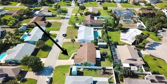 an aerial view of residential houses with outdoor space and street view