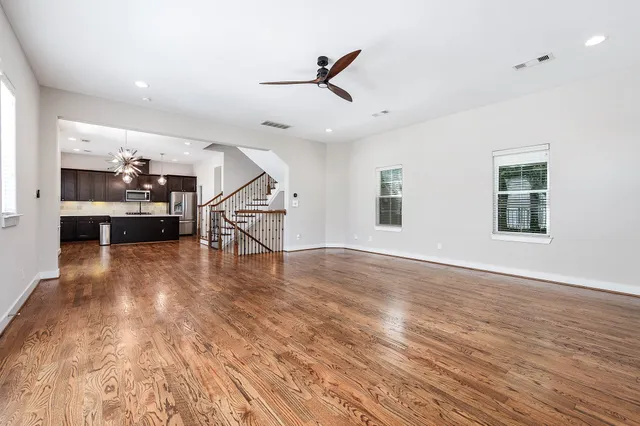 a view of a livingroom with furniture wooden floor and chandelier