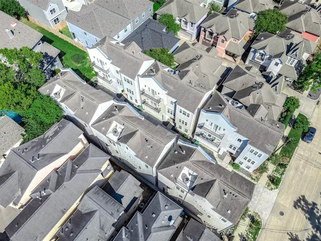 an aerial view of multiple houses with outdoor space