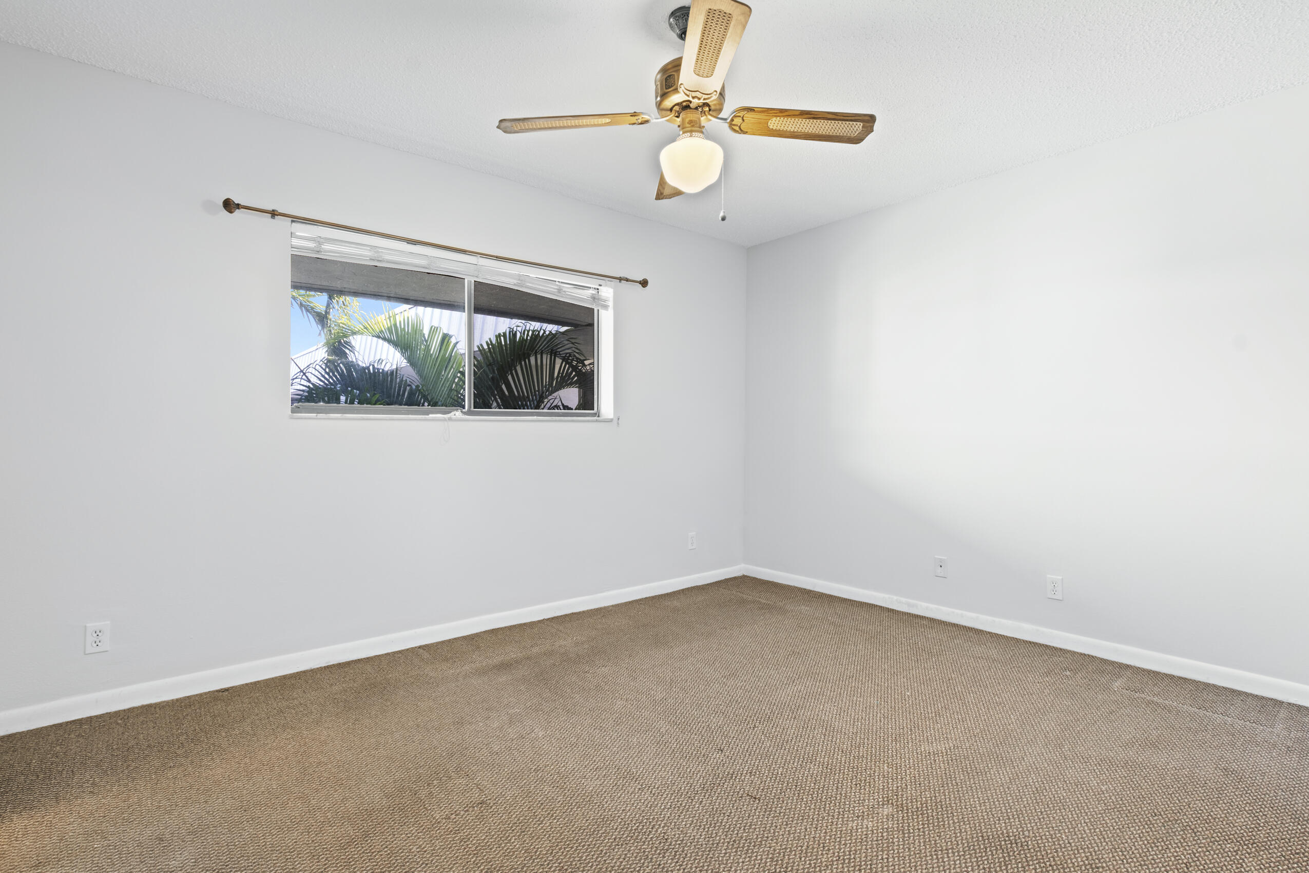 825 Northwest 13th Street, Unit 223 Boca Raton, FL 33486 - Photo 24 of 42 an empty room with a window and a fan