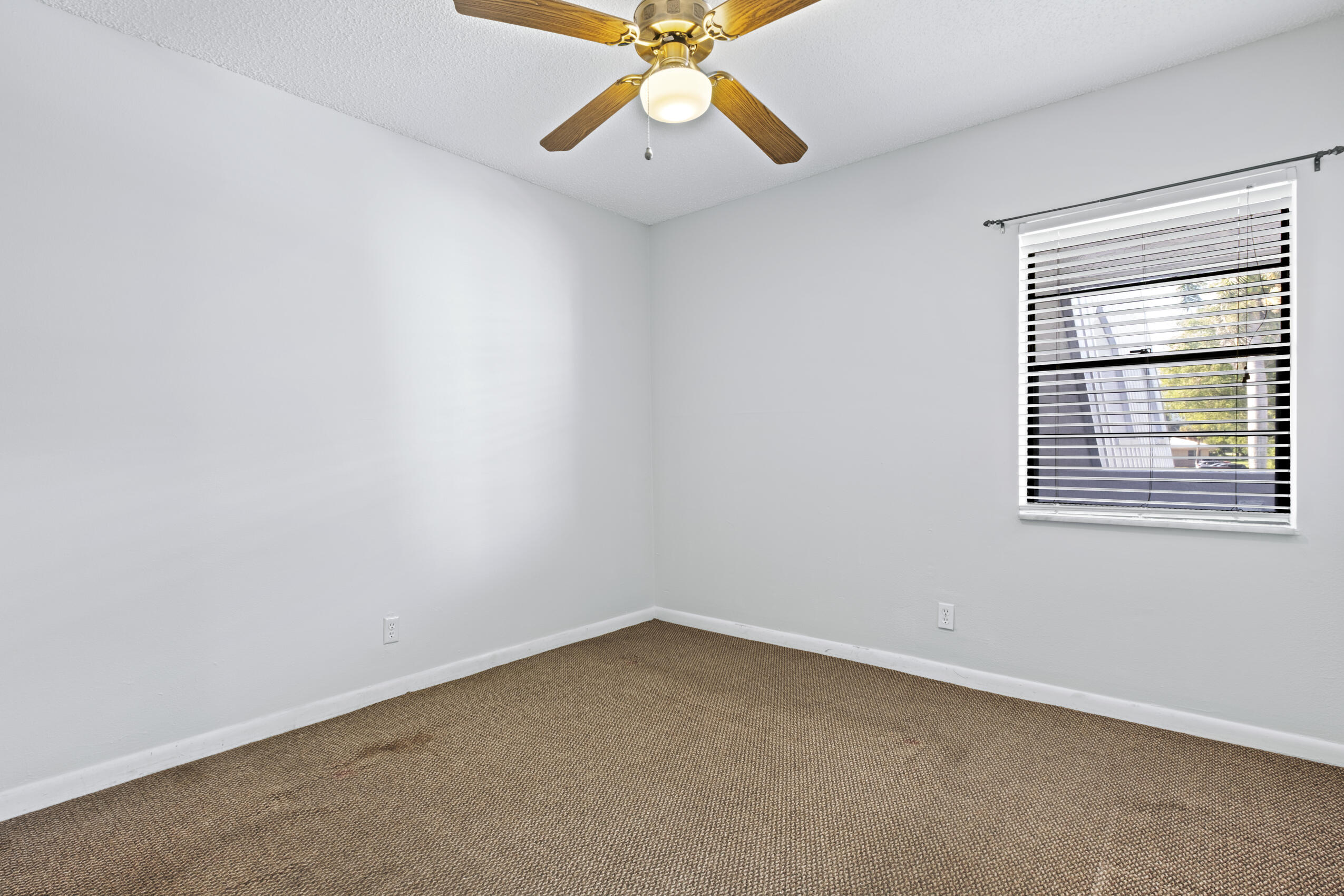 825 Northwest 13th Street, Unit 223 Boca Raton, FL 33486 - Photo 30 of 42 an empty room with a window and a fan