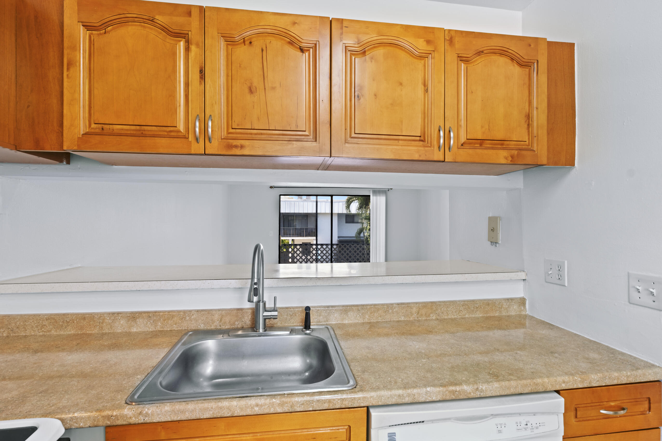 825 Northwest 13th Street, Unit 223 Boca Raton, FL 33486 - Photo 42 of 42 a kitchen with granite countertop a sink and cabinets