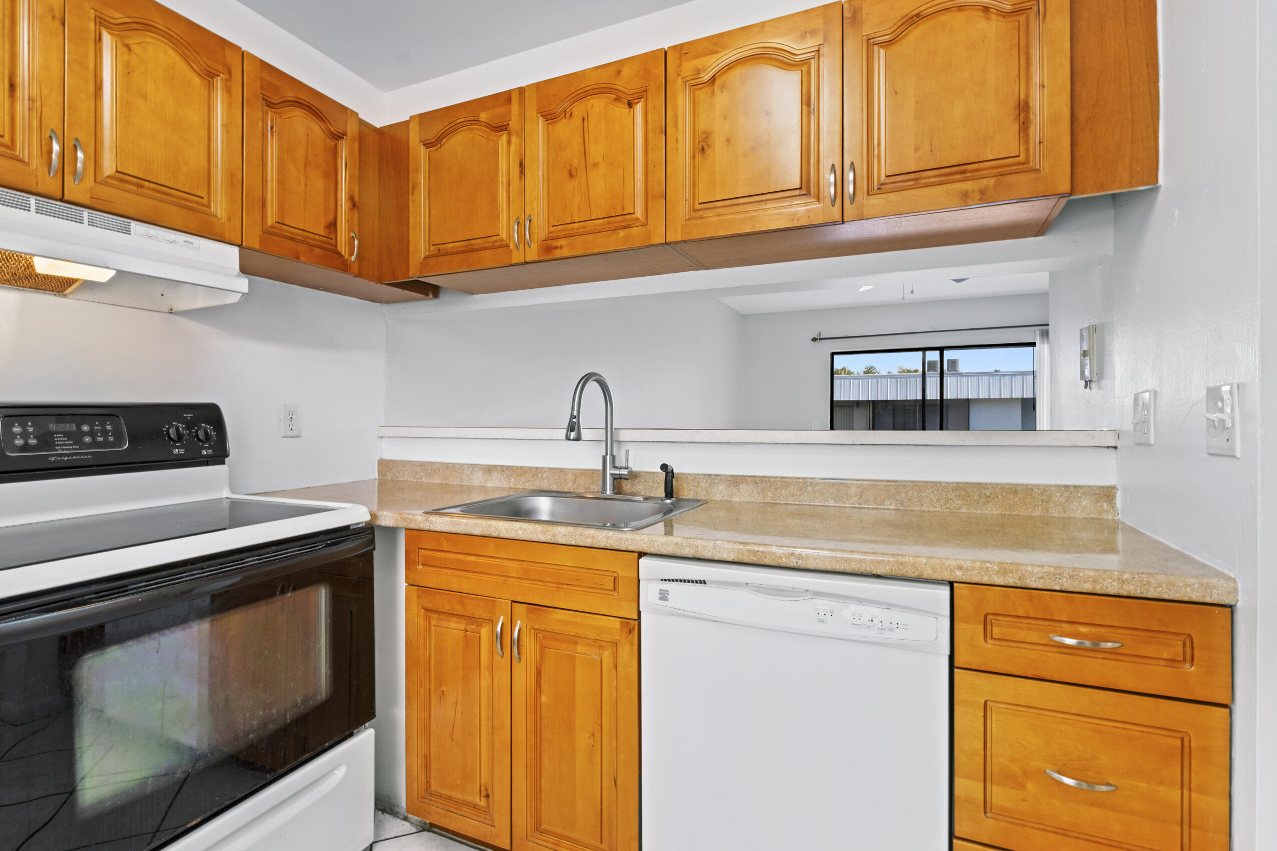 825 Northwest 13th Street, Unit 223 Boca Raton, FL 33486 - Photo 9 of 42 a kitchen with stainless steel appliances granite countertop a sink and cabinets
