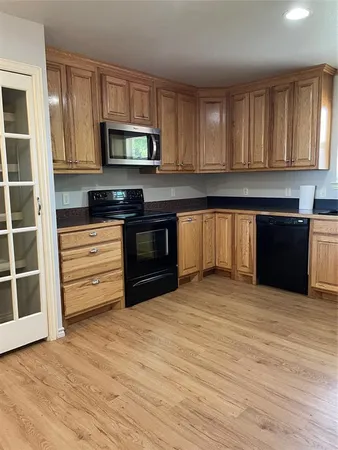 a kitchen with stainless steel appliances granite countertop a stove and a microwave