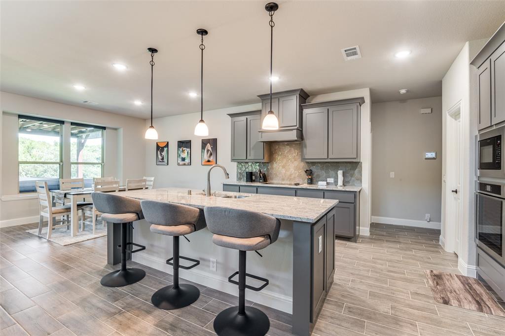 4810 Nomad Drive Midlothian, TX 76065 - Photo 14 of 39 a large kitchen with a table and chairs in it
