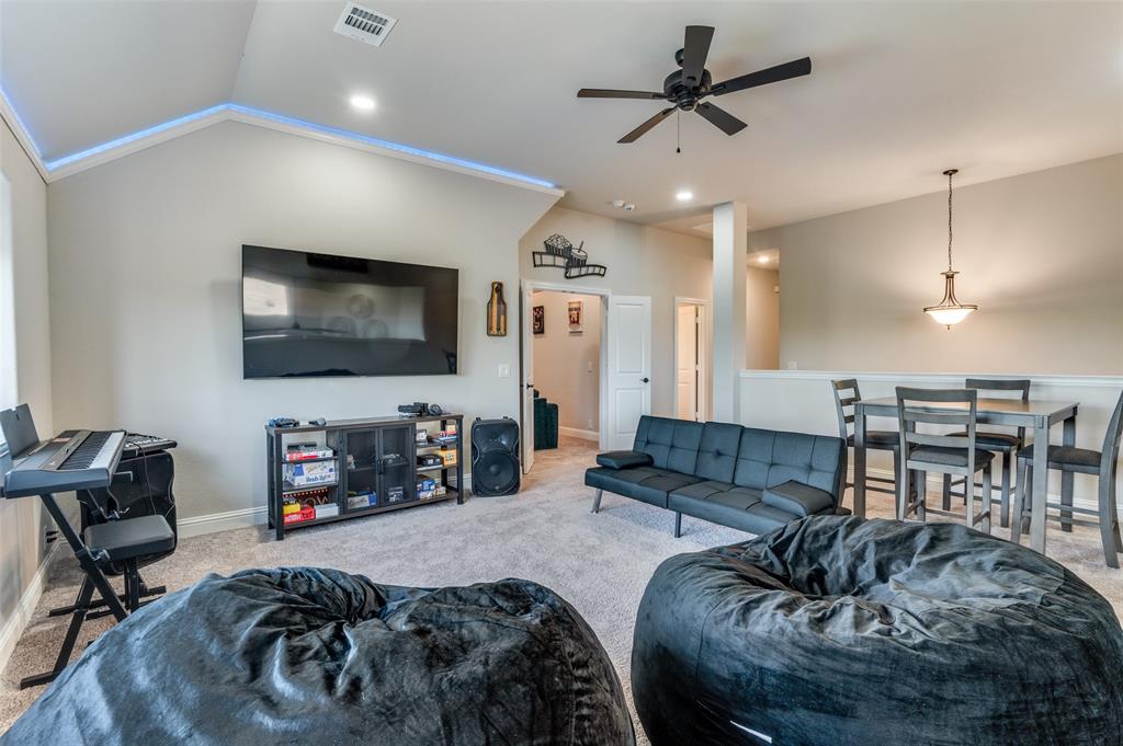 4810 Nomad Drive Midlothian, TX 76065 - Photo 15 of 39 a living room with furniture and a flat screen tv