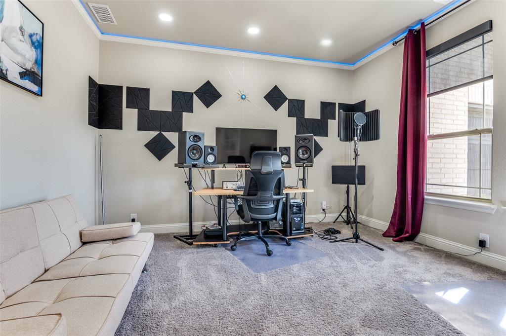 4810 Nomad Drive Midlothian, TX 76065 - Photo 18 of 39 a living room with furniture a fireplace and a flat screen tv
