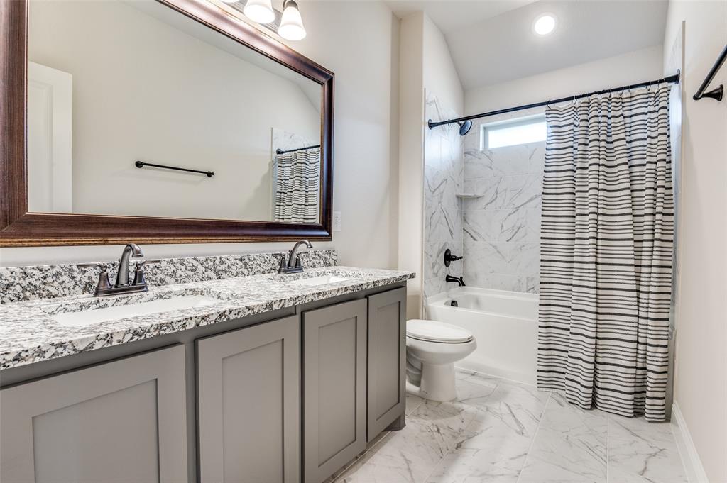 4810 Nomad Drive Midlothian, TX 76065 - Photo 22 of 39 a bathroom with a granite countertop sink toilet and shower