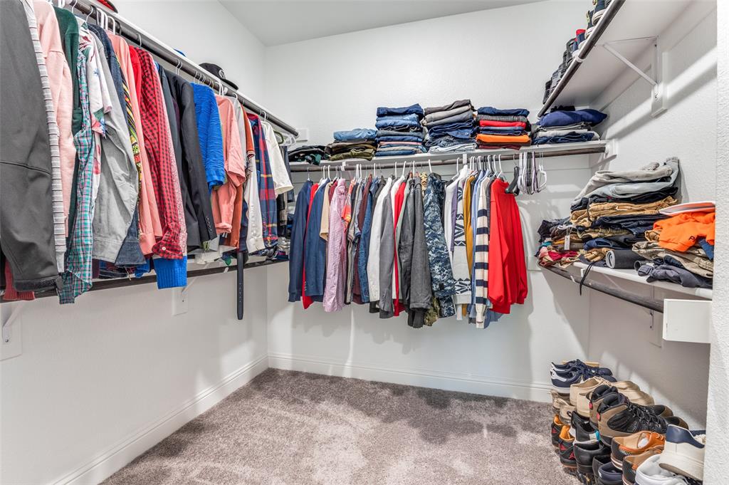 4810 Nomad Drive Midlothian, TX 76065 - Photo 27 of 39 a view of walk in closet with clothes and shoes