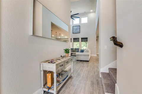 a view of a livingroom with furniture and a floor to ceiling window