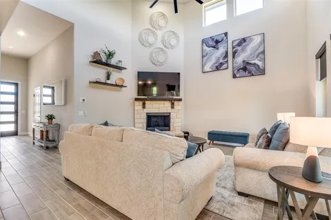 a living room with furniture a flat screen tv and kitchen view