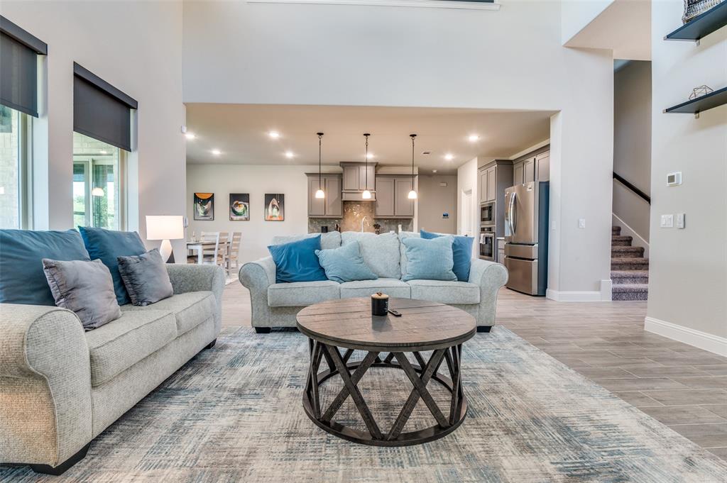 4810 Nomad Drive Midlothian, TX 76065 - Photo 7 of 39 a living room with furniture a kitchen view and a chandelier