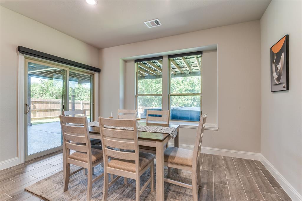 4810 Nomad Drive Midlothian, TX 76065 - Photo 9 of 39 a view of a dining room with furniture and wooden floor
