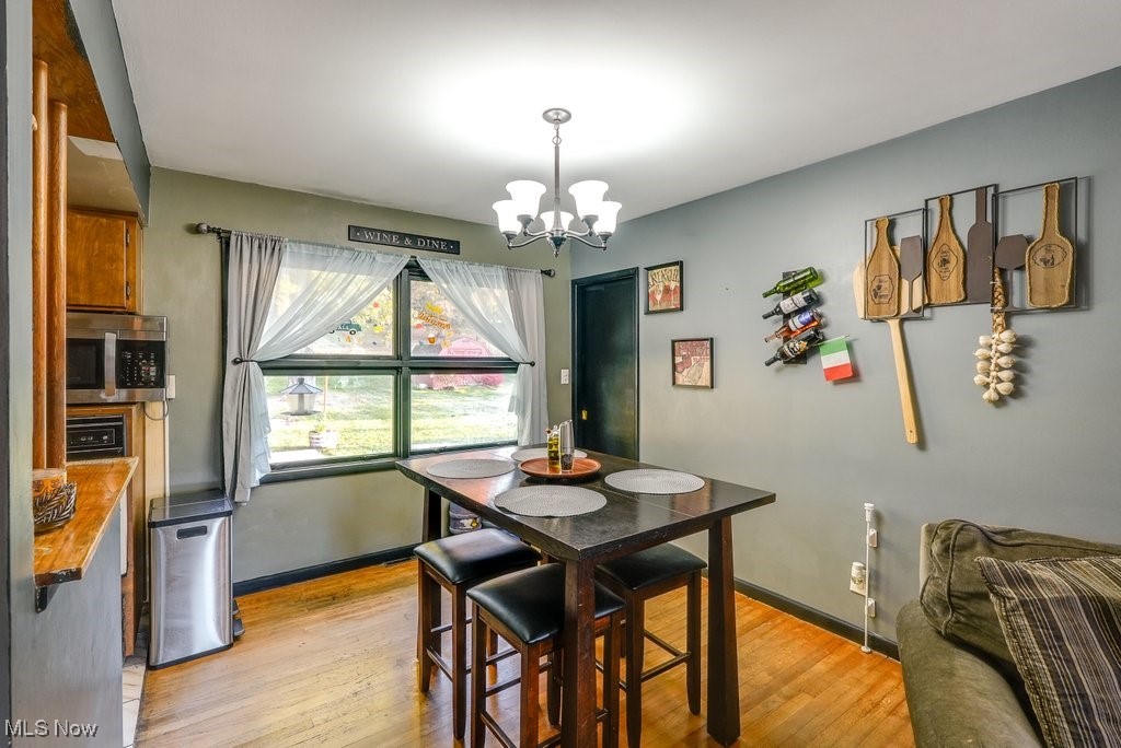 333 East Caston Road Akron, OH 44319 - Photo 10 of 42 Dining room featuring light hardwood / wood-style flooring and an inviting chandelier