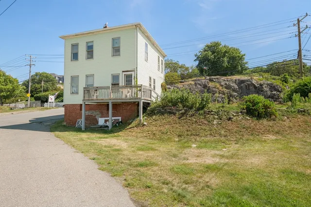 a view of a house with backyard and sitting area