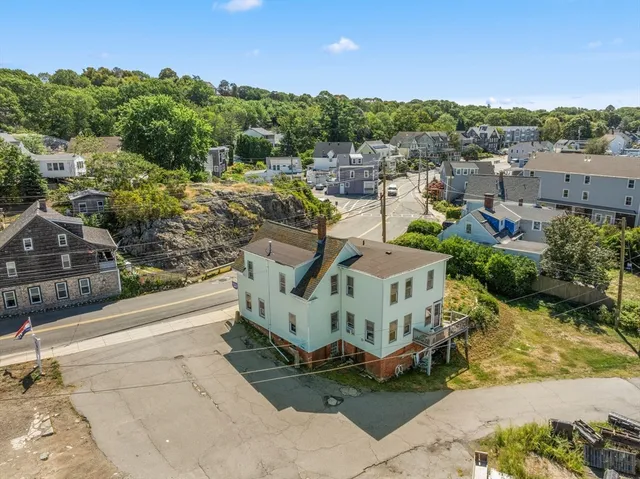 a view of a house with a yard and sitting area