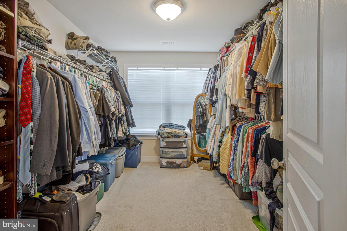 54 Simmons Ridge Road Prince Frederick, MD 20678 - Photo 33 of 55 a view of walk in closet with clothes and shoes