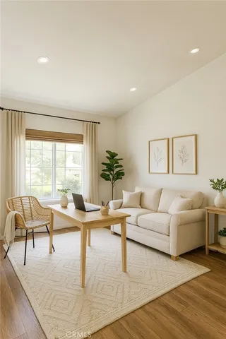 a living room with furniture and view of kitchen