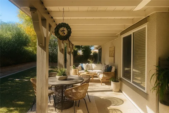 a view of a patio with table and chairs and potted plants